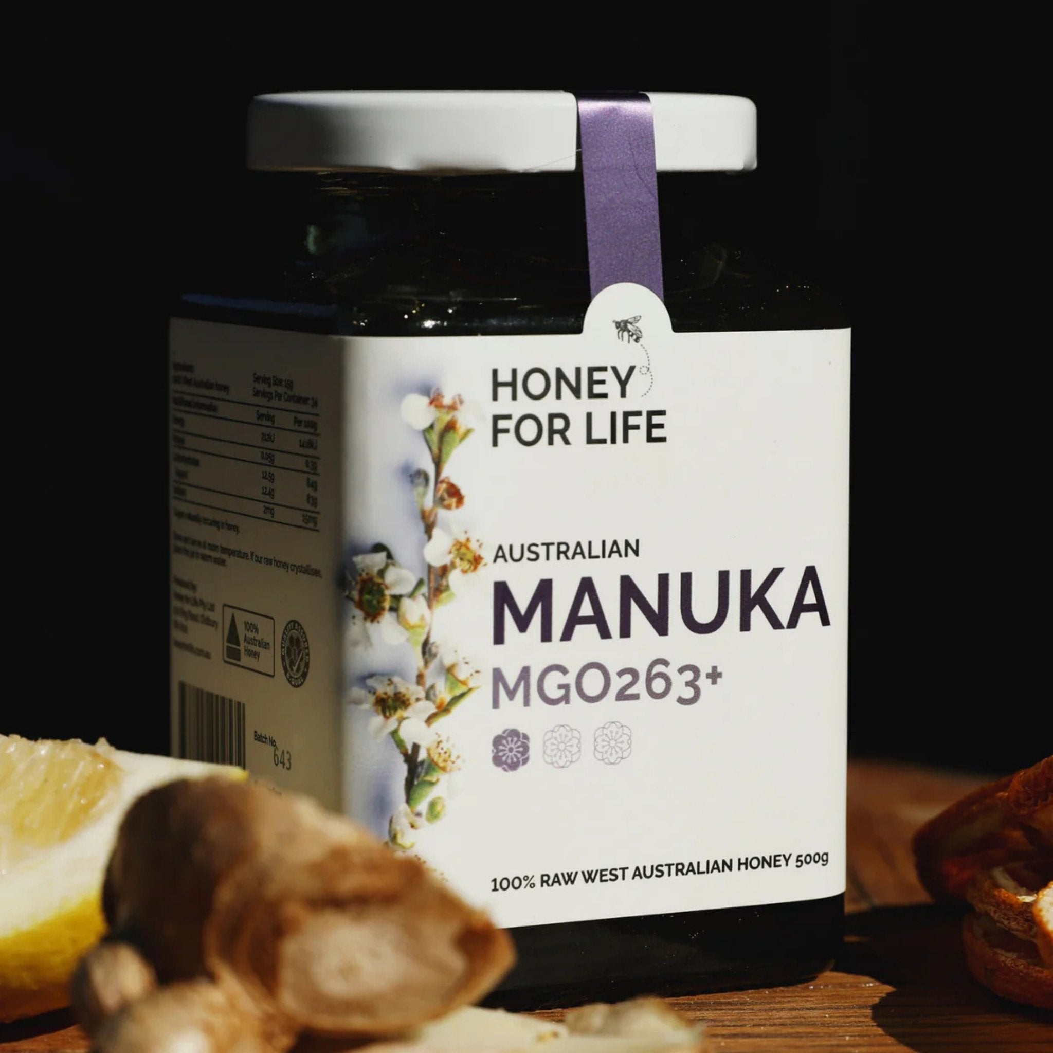 a close up shot of a Manuka honey jar on top of a table.
