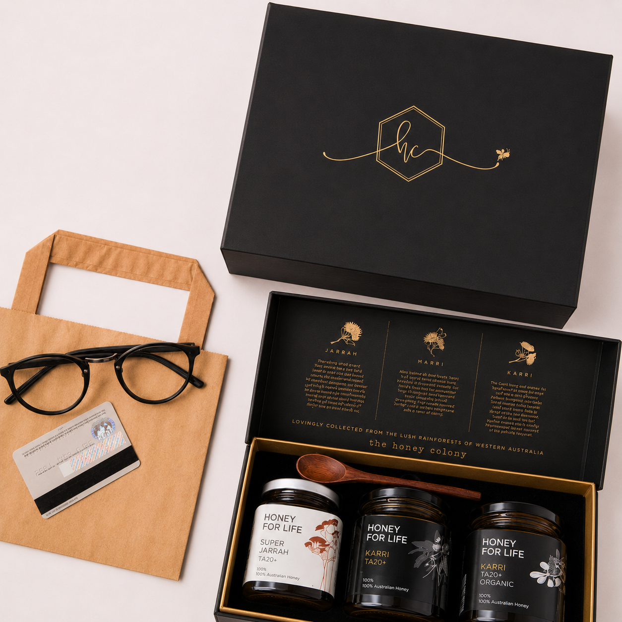 Premium honey corporate gift box with three jars, kraft paper bag, glasses and card for thoughtful corporate gifting.