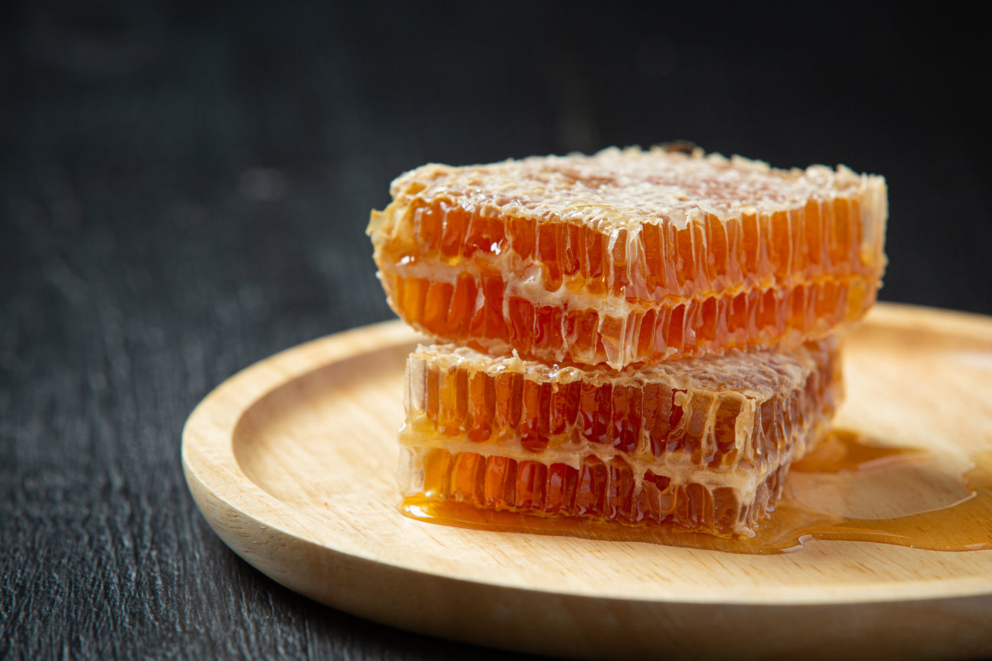 fresh honeycombs dark wooden surface.
