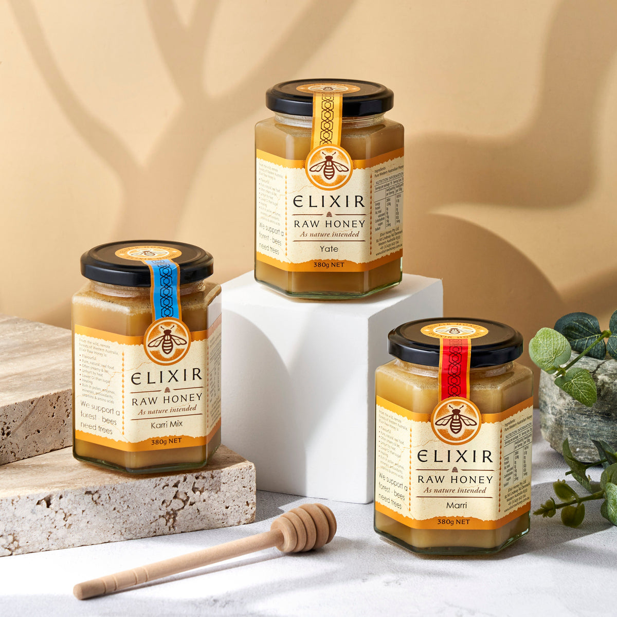 Jar of Elixir Raw Jarrah Honey with a black and orange label on a white background