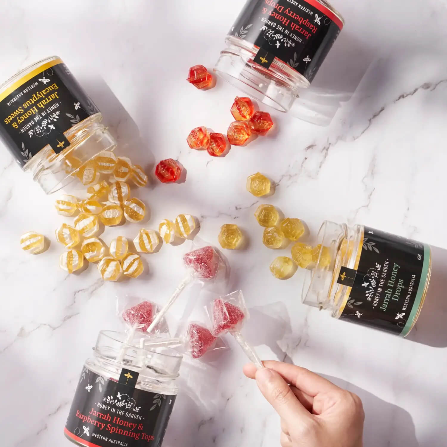 four opened jars of honey candy