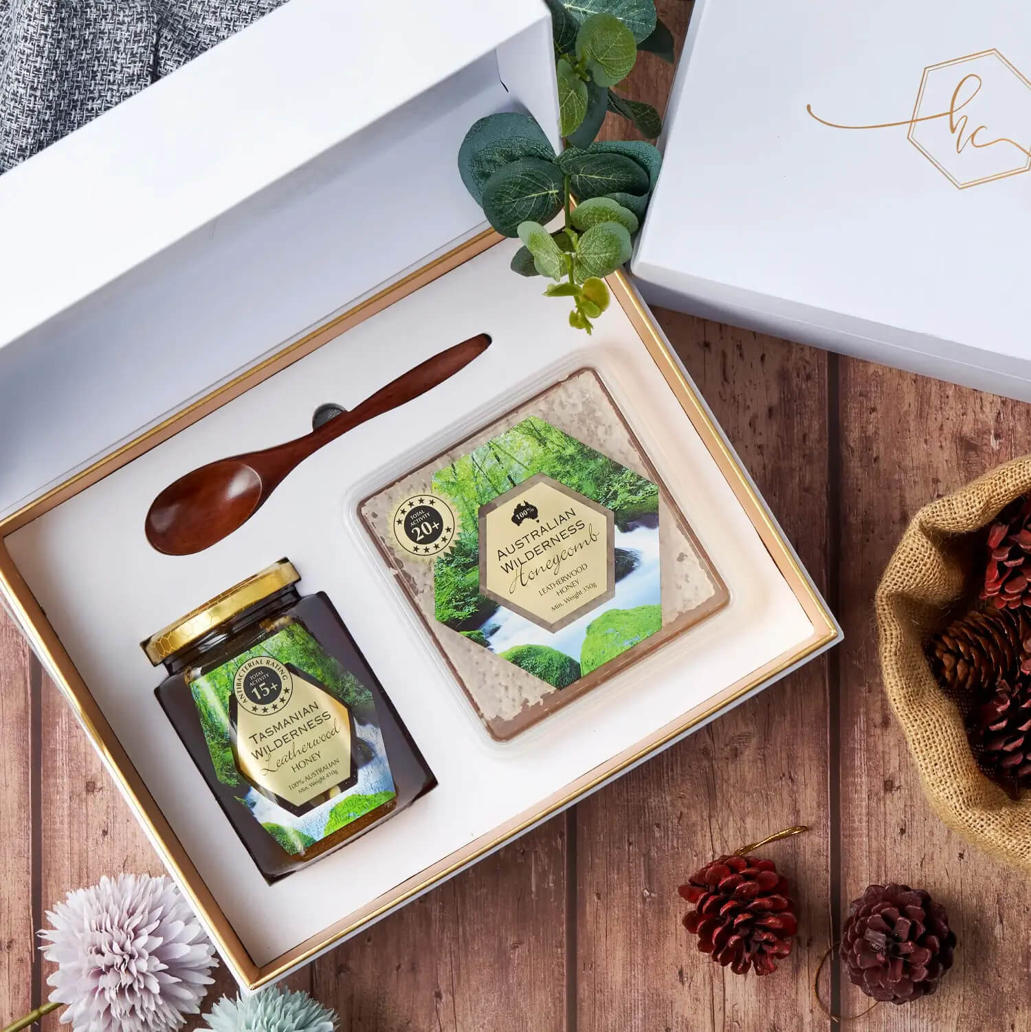 open honey gift box with honey jar and spoon