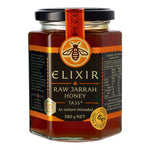 Jar of Elixir Raw Jarrah Honey with a black and orange label on a white background