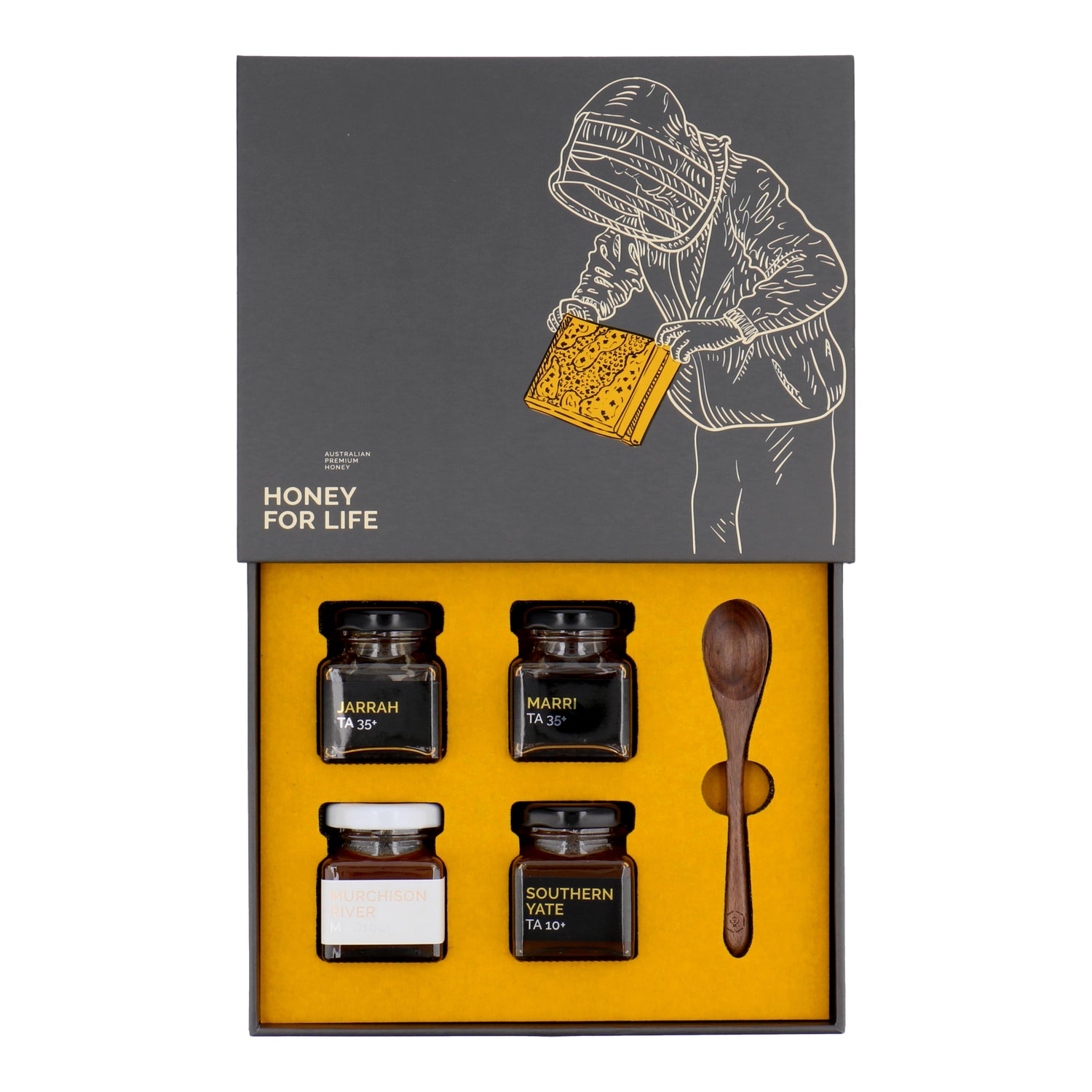 The Petite Four Honey Gift Set with open box showing 4 honey jars and a wooden spoon