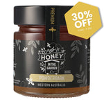 Jar of honey with 'Honey in the Garden Powderbark' label and a 30% off tag on a white background