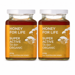 Two glass jars of 'Honey For Life' Super Active TA 60+ Organic honey with white lids, displayed side-by-side on a white background.