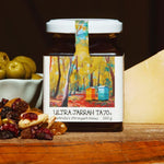 Jar of Ultra Jarrah TA70+ honey with a colorful label on a wooden surface.