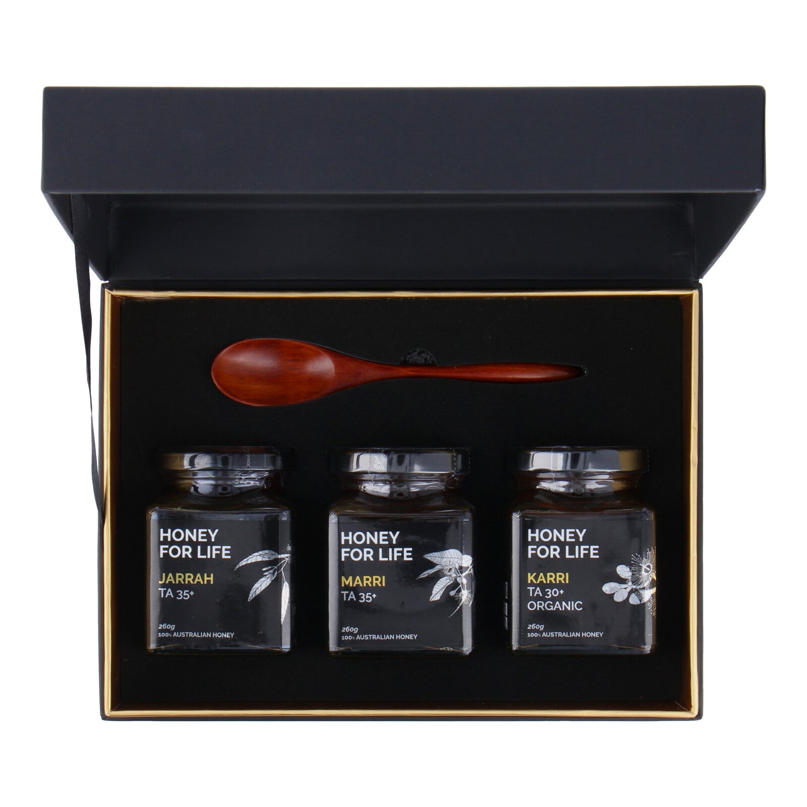 open box in top view of honey gifts with a wooden spoon in an open gift box