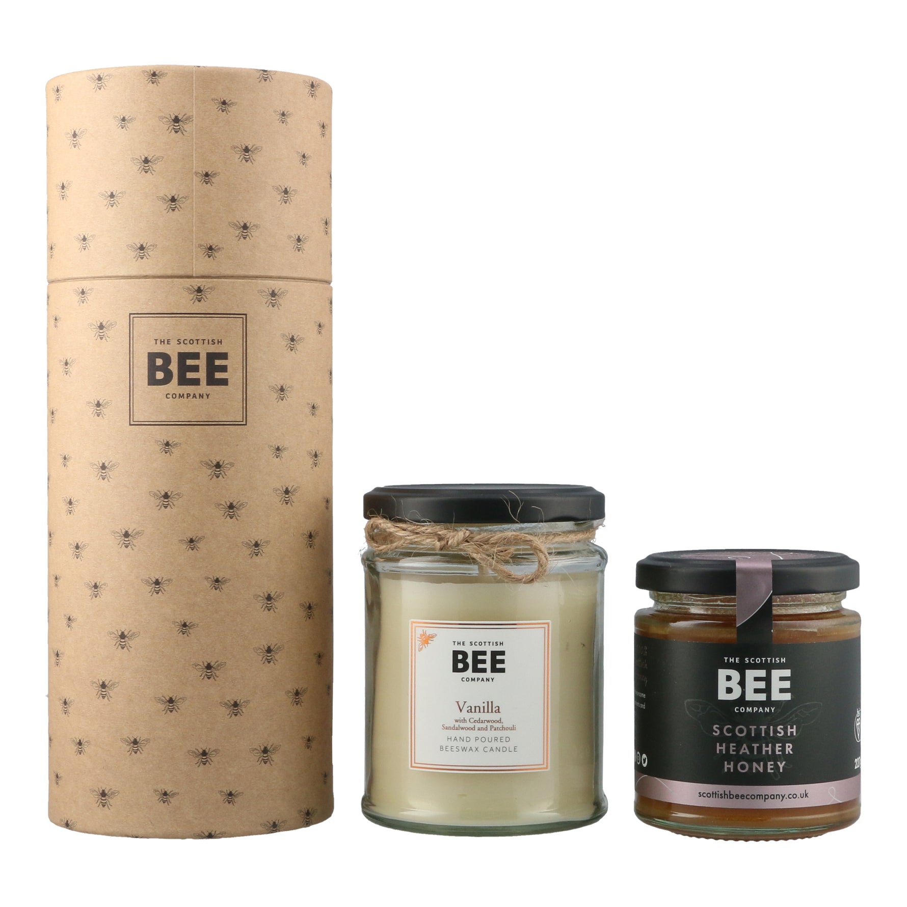 A gift set of Scottish Beeswax candle with vanilla, cedarwood, and patchouli scents, presented in glass jar with a paper packaging sleeve. It comes with a jar of Scottish Heather Honey.