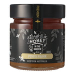 A jar of Powderbark honey labeled 'Honey in the Garden' with a weight indication of 300g, and text stating it is a product from Western Australia.