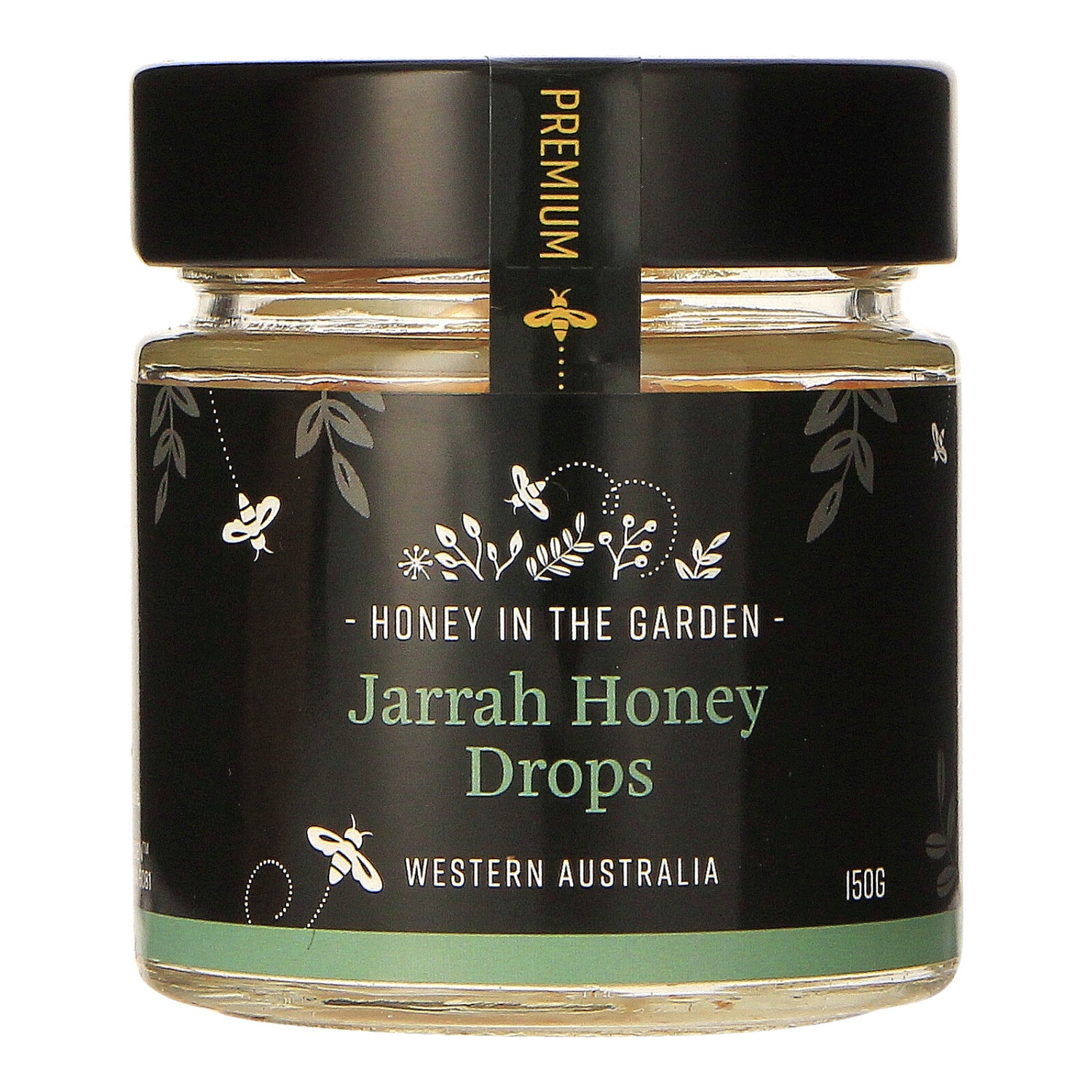 A jar of Jarrah Honey Drops with a label that includes the brand name 'Honey in the Garden' and the product name 'Jarrah Honey Drops', indicating the product is a food item, specifically honey candy. The jar is sealed with a black lid and has a green band indicating a weight of 150g.
