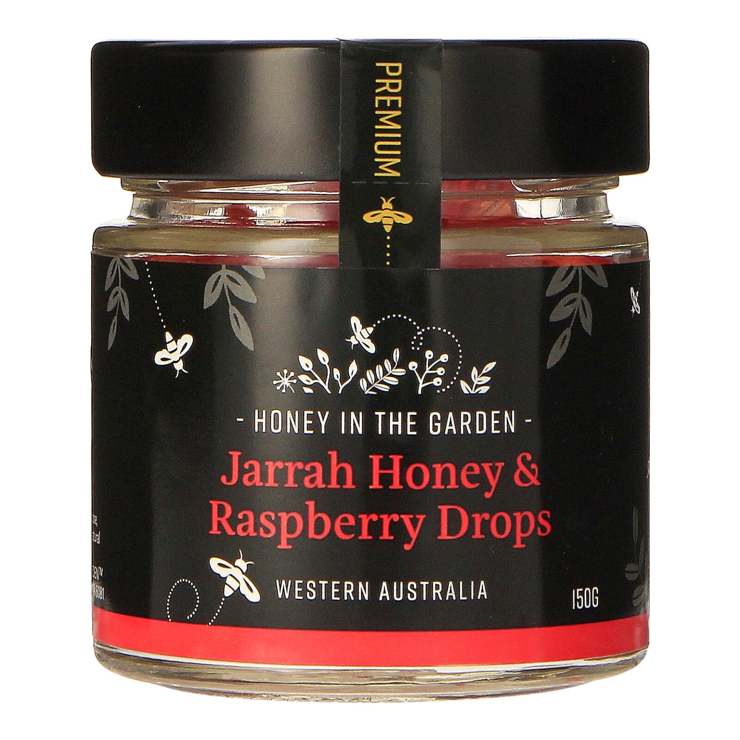 A jar of Jarrah Honey & Raspberry Drops with a label that includes images of honeycombs, raspberries, and a bee. The text on the label reads 'Honey in the Garden' and 'Jarrah Honey & Raspberry Drops, Western Australia 150g'.