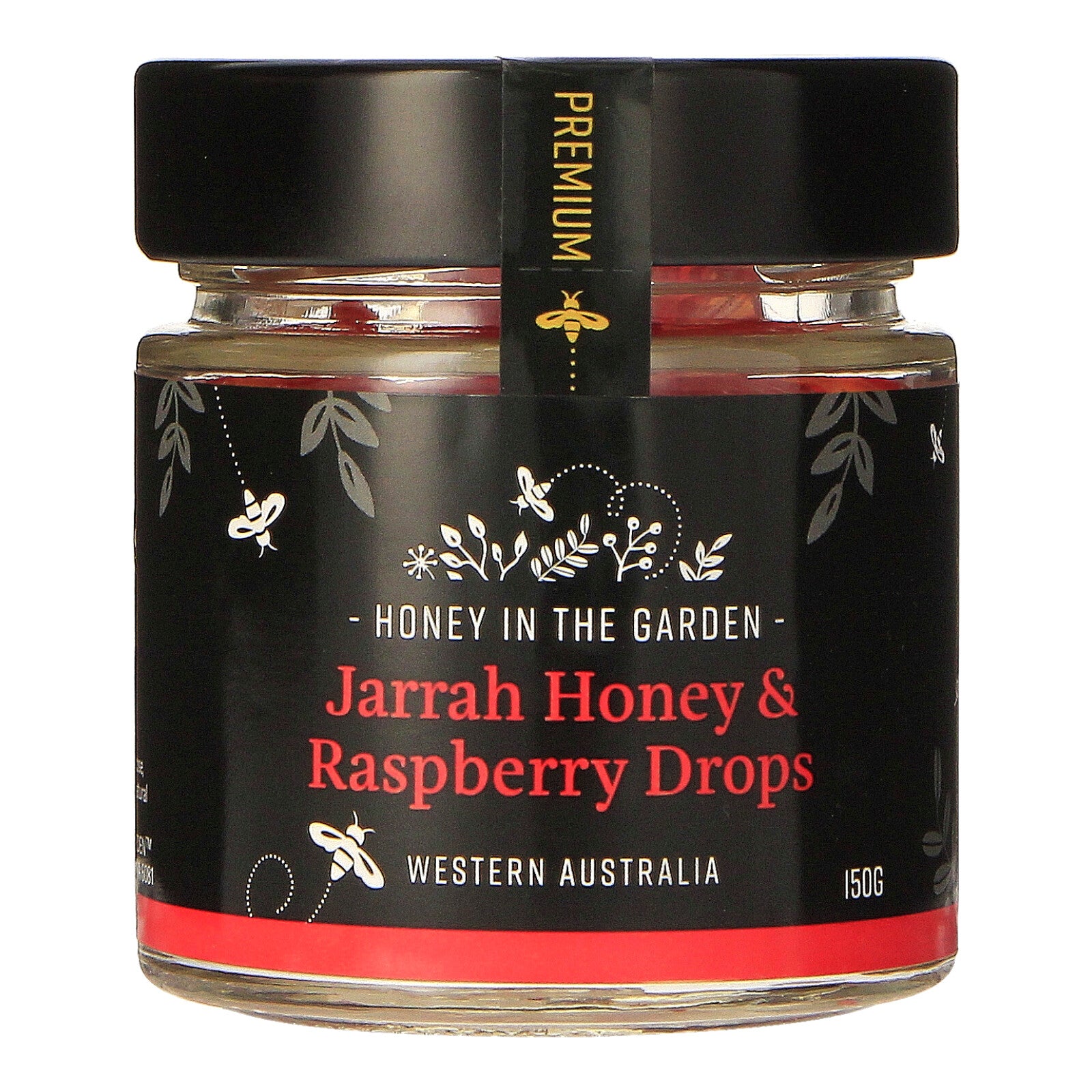 A jar of Jarrah Honey & Raspberry Drops with a label that includes images of honeycombs, raspberries, and a bee. The text on the label reads 'Honey in the Garden' and 'Jarrah Honey & Raspberry Drops, Western Australia 150g'.