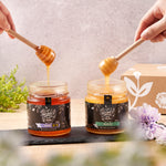 two open jars from the Honey in the Garden gift box with hands holding a dipper above each one